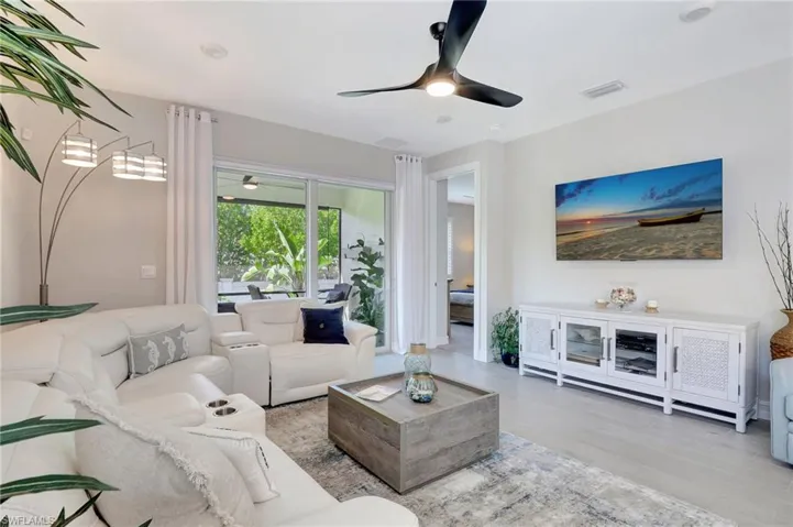 Living room featuring ceiling fan and light hardwood / wood-style flooring