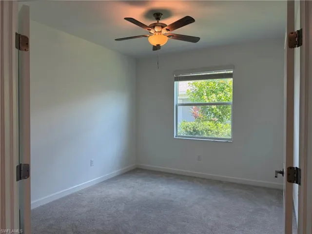 Neutral tone walls with gray carpeting