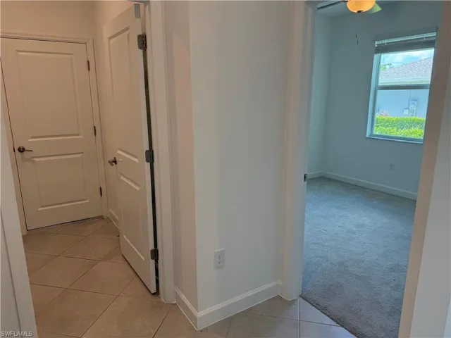 Interior hallway featuring bedroom 2 and entrance to garage