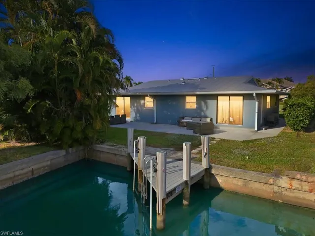 Rear view of house featuring a patio and a lawn