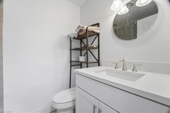 Bathroom featuring vanity and a shower