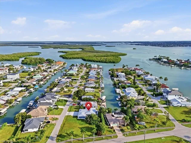 Aerial overview of property's location with nearby suburban area and a nearby body of water