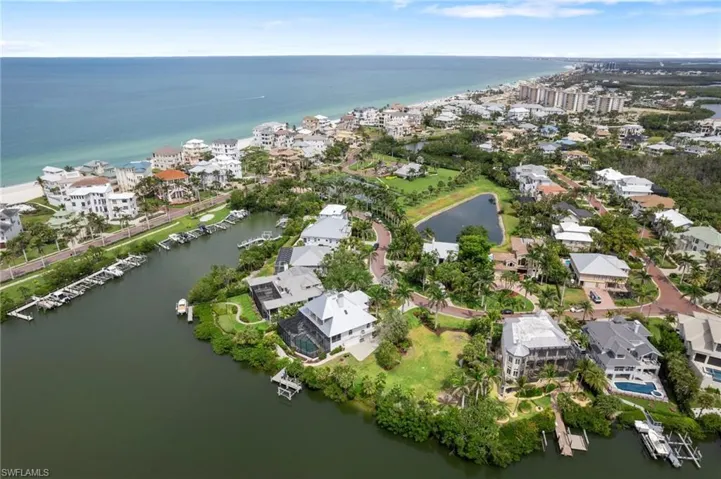 Aerial overview of property's location with a large body of water and nearby suburban area