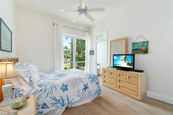 Bedroom featuring light wood finished floors, access to outside, baseboards, and a ceiling fan