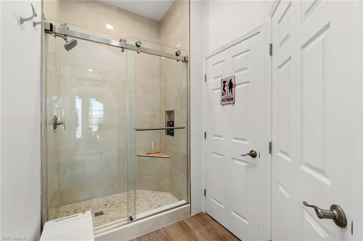 Full bathroom with wood finished floors and a stall shower