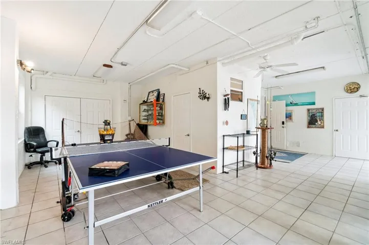 Playroom with ceiling fan and light tile patterned flooring