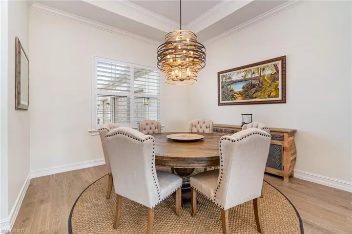 Dining space with crown molding, tiled flooring, and a chandelier