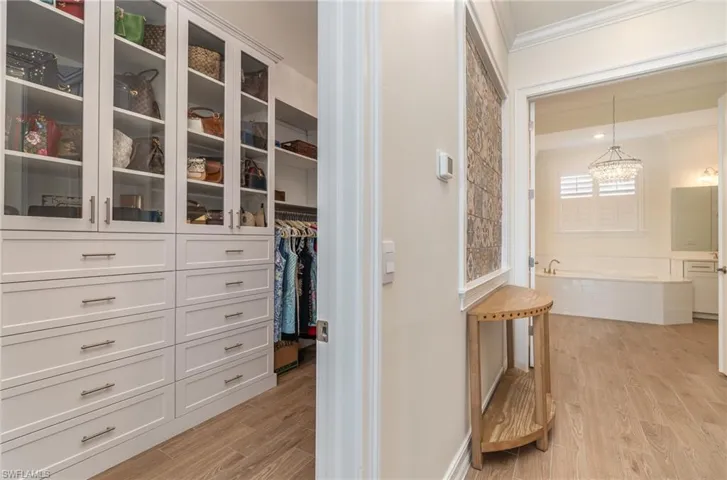 Spacious closet with custom shelving and  tiled flooring