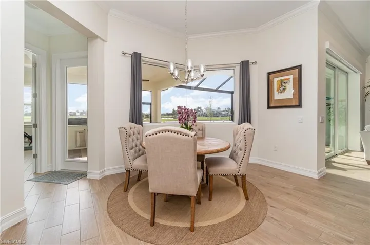 Dining kitchen featuring a chandelier,  tiled flooring, and crown molding
