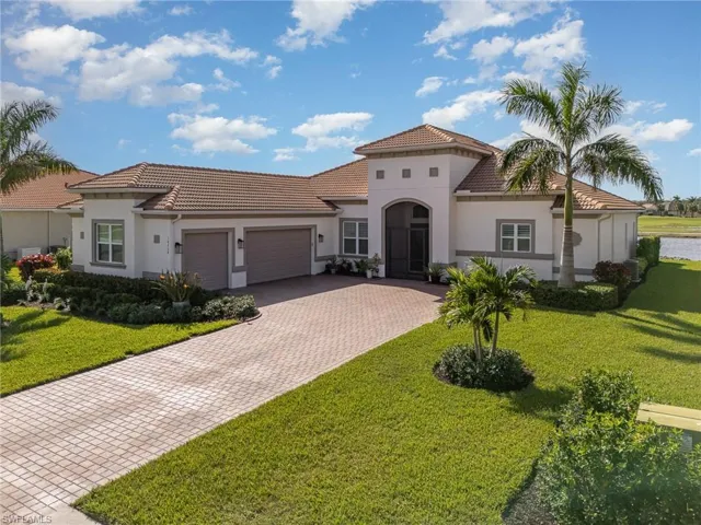 Mediterranean / spanish home with a  3 garage and professionally landscaped lawn