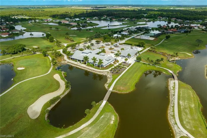 Clubhouse aerial view and water featuring