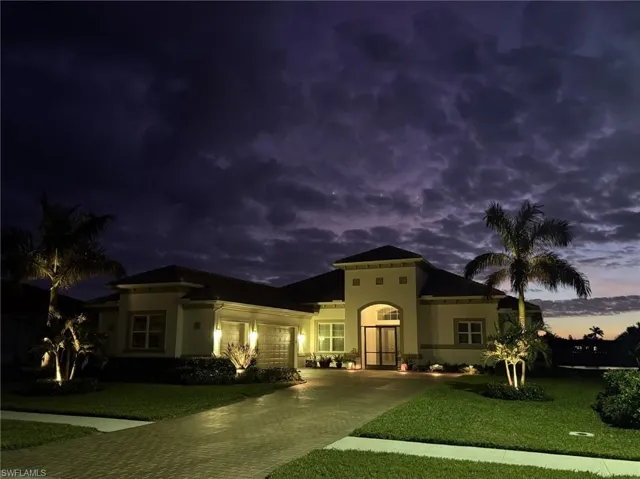 Mediterranean / spanish home featuring a 3 garage and professionally landscaped lawn