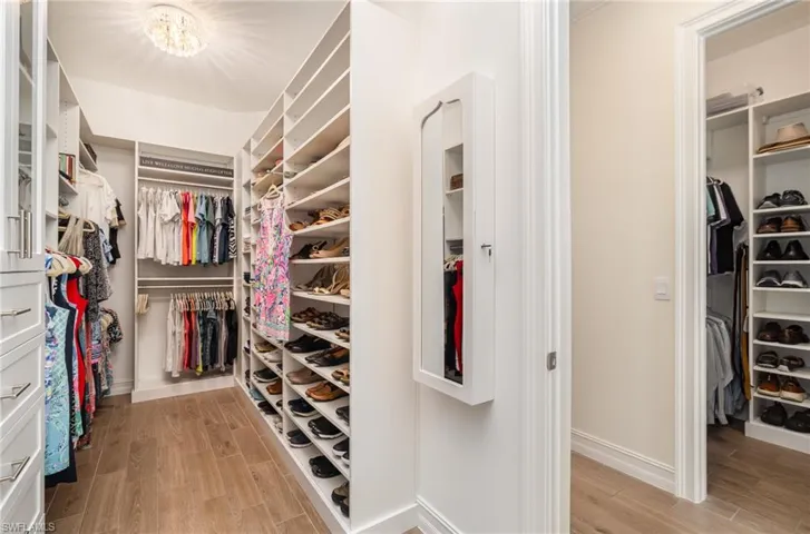 Spacious closet with custom shelving and  tiled flooring