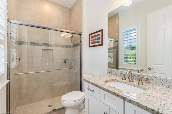 ENSUITE Bathroom /BEDROOM featuring vanity, toilet, and a shower with door