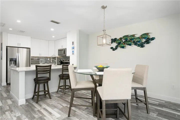 Dining room featuring light wood-style flooring and recessed lighting