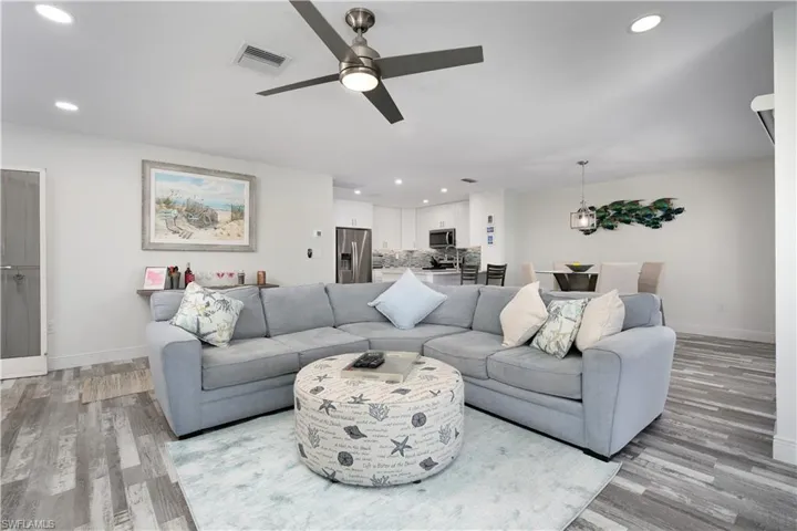 Living area featuring recessed lighting, a ceiling fan, and light wood-style flooring