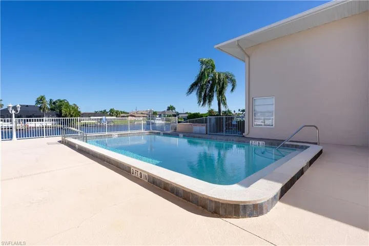 Community pool with a patio
