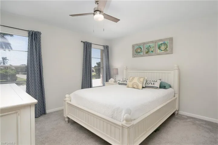 Bedroom featuring a ceiling fan and light colored carpet