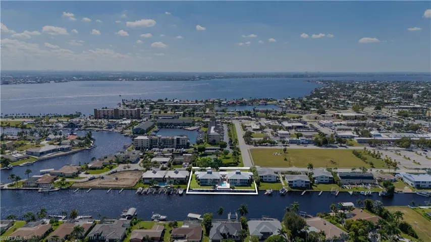 Aerial view of residential area featuring a large body of water