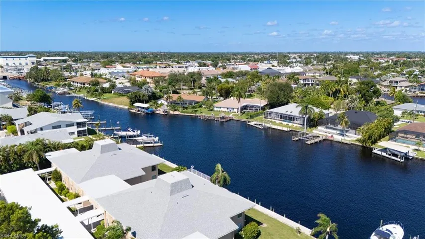 Aerial view of residential area featuring a nearby body of water