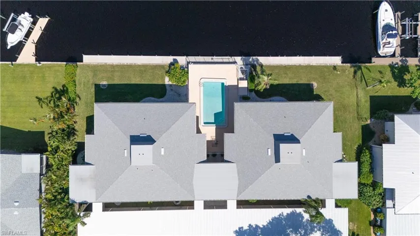Aerial view of property and surrounding area with a pool