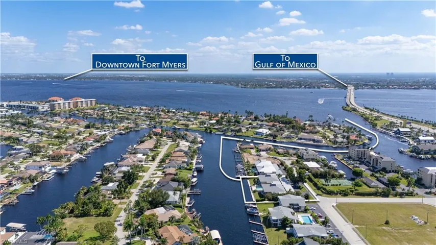 Aerial perspective of suburban area featuring a large body of water