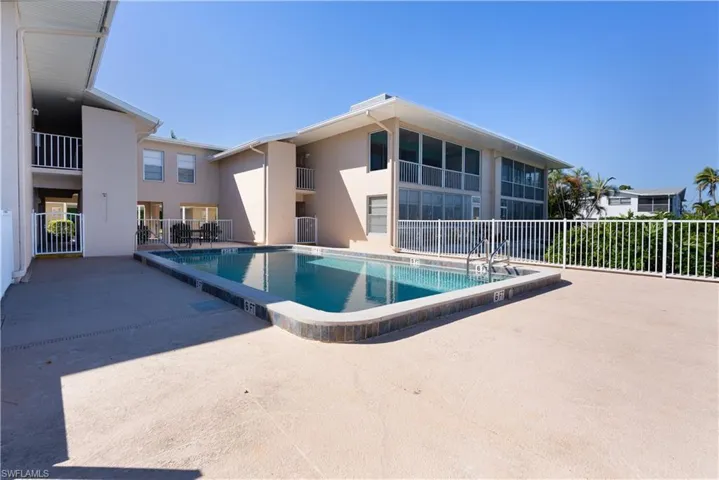 Community pool featuring a patio and a balcony