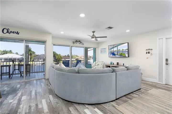 Living room featuring ceiling fan, recessed lighting, and light wood-style flooring
