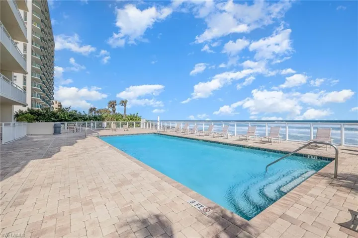 Community pool with a patio