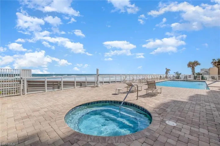 Community pool with a community hot tub and a patio area