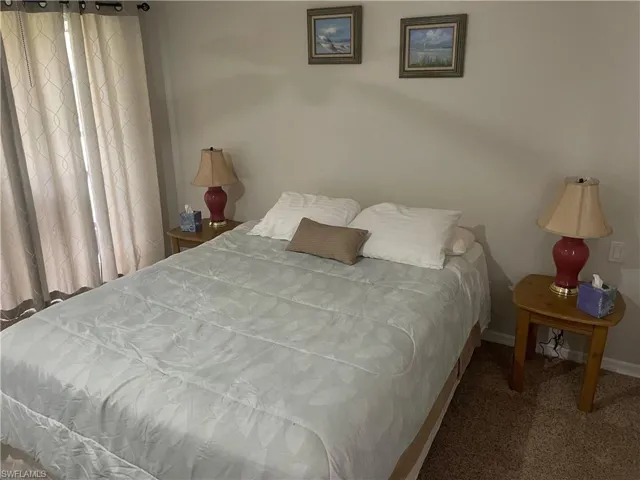 Bedroom with carpet floors and baseboards