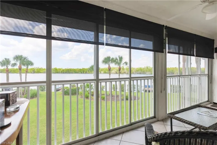 Sunroom / solarium featuring ceiling fan, plenty of natural light, and a water view