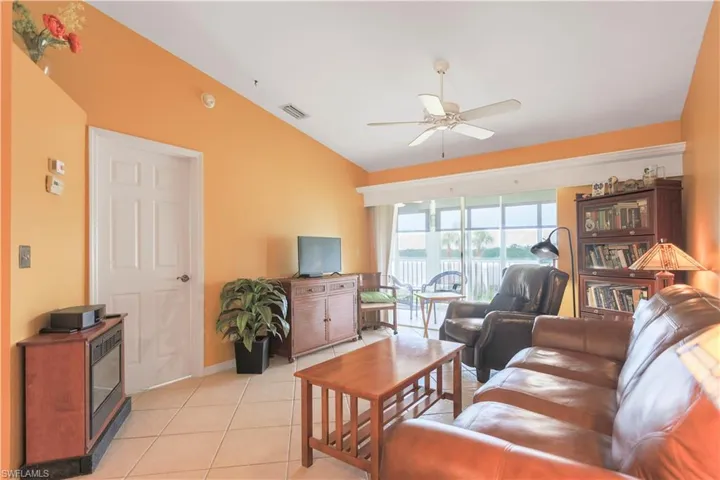 Tiled living room featuring ceiling fan