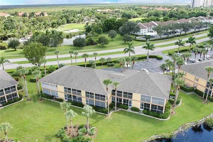 Birds eye view of property with a water view