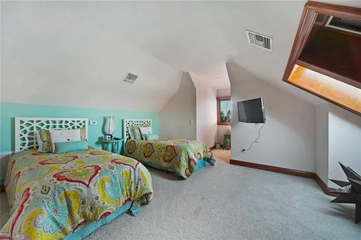 Third level 7th en-suite w/carpeted floors, lofted ceiling, huge walk-in closet & skylights