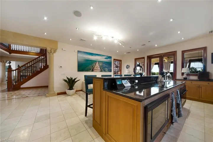 Open Concept Kitchen with dbl French Doors leading to Pool & Outdoor Dining