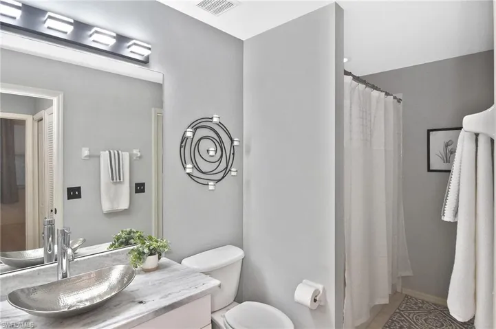 Full bathroom with vanity and toilet