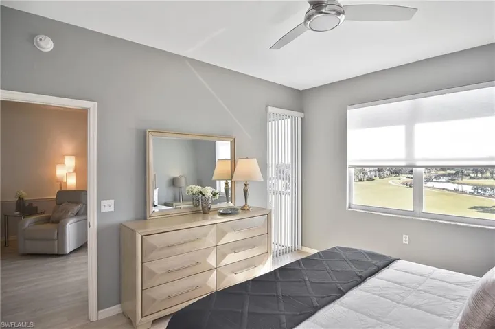 Bedroom with ceiling fan and light wood-style floors