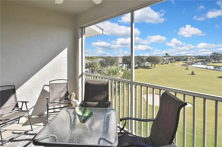 Balcony with a water view and golf course view