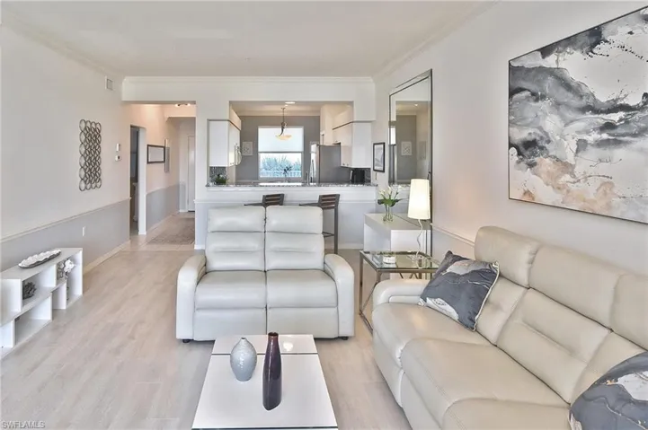 Living room featuring light wood-style floors and ornamental molding
