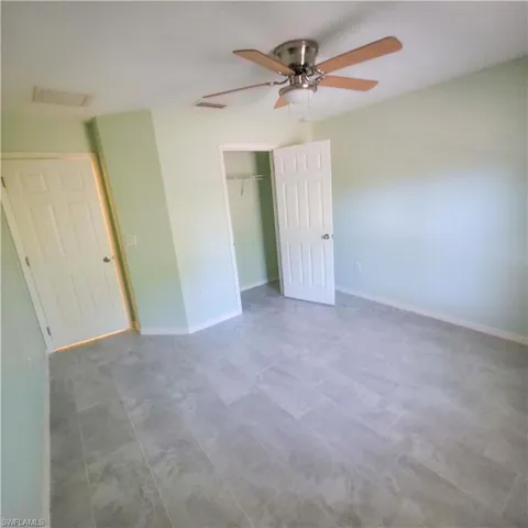 3rd bedroom with a ceiling fan and a closet