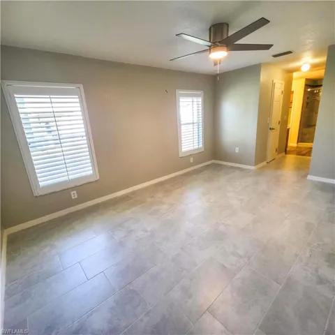 Primary room with baseboards and a ceiling fan