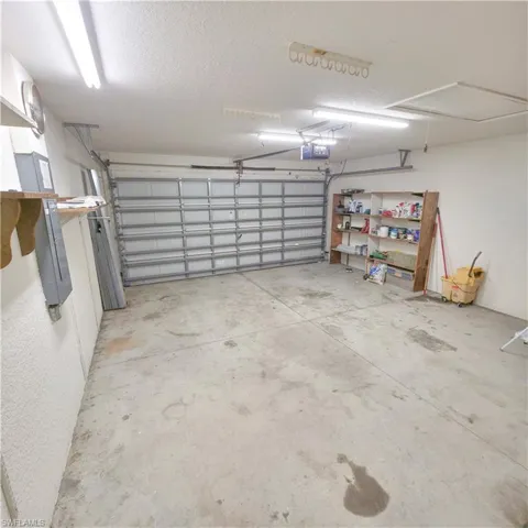 Garage with electric panel and a garage door opener