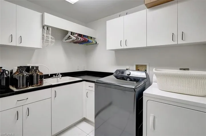 laundry room with sink, storage and countertops