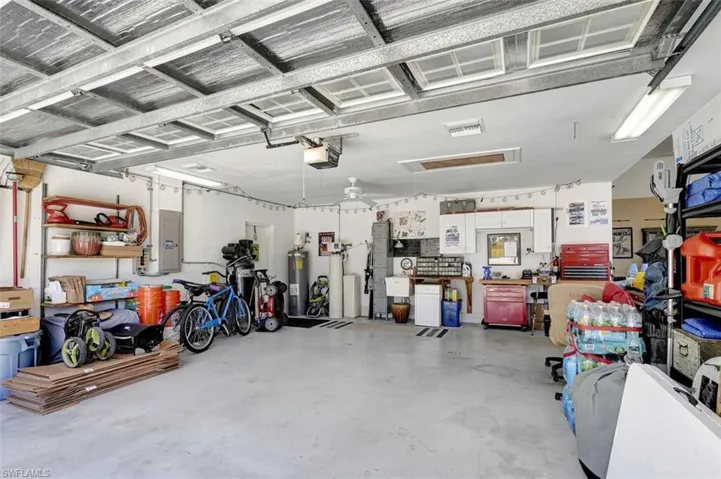 Interior of 2 bay garage area with sink, generator hook-up and swing door