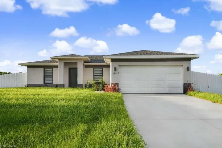 Prairie-style home with stucco siding, concrete driveway, and a garage