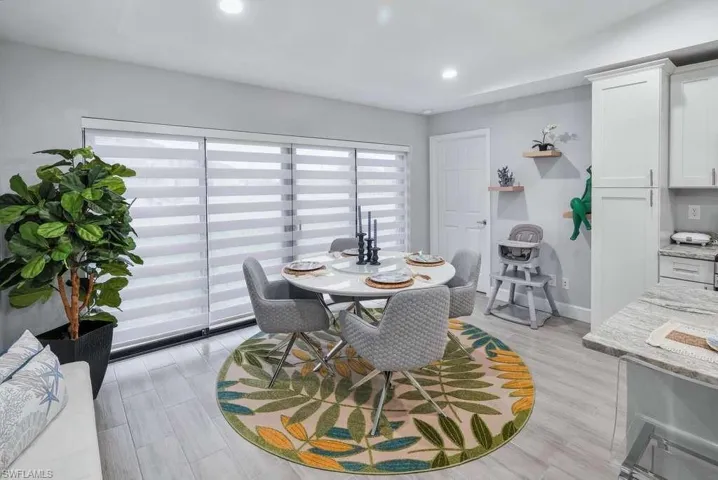 Dining space with light wood-type flooring and recessed lighting