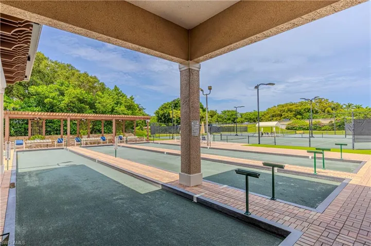 View of home's community center with a bocce ball area and a tennis court