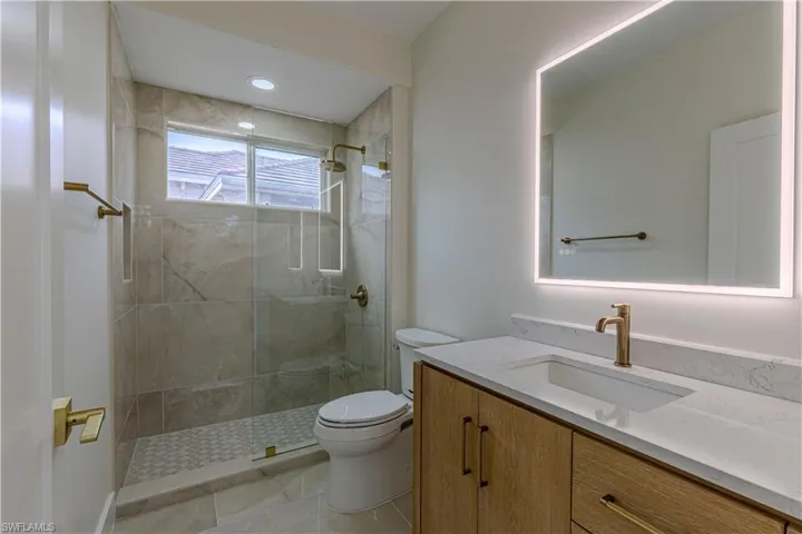 Guest Bathroom with vanity and a tile shower