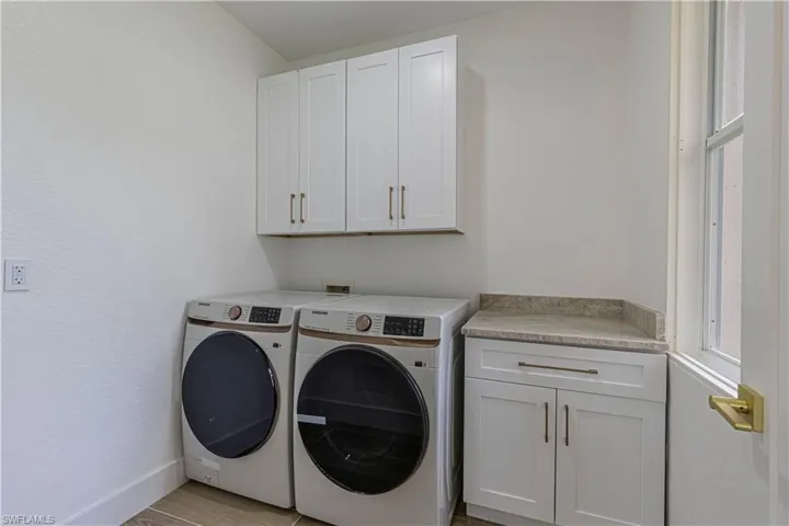Laundry room with cabinet space and independent washer and dryer